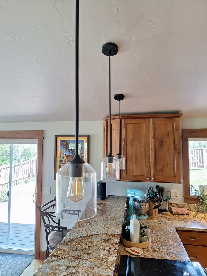 Pendant lighting installation over a kitchen island in Steamboat Springs